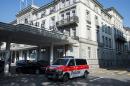 A police vehicle is parked outside of the five-star hotel Baur au Lac in Zurich, Switzerland, Wednesday morning, May 27, 2015. The Swiss Federal Office of Justice said six soccer officials have been arrested and detained pending extradition at the request of U.S. authorities ahead of the FIFA congress in Zurich. In a statement Wednesday the FOJ said U.S. authorities suspect the officials of having received paid bribes totaling millions of dollars. (Ennio Leanza/Keystone via AP)