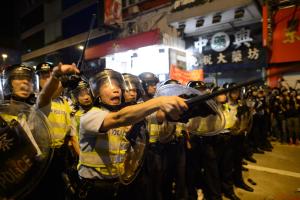 Policemen holding batons advance towards pro-democracy&nbsp;&hellip;