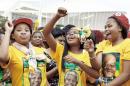African National Congress (ANC) supporters celebrate during the victory celebrations of the ANC at the Peoples Park outside the Moses Mabhida Football stadium in Durban on May 10, 2014