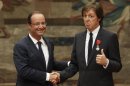 French President Francois Hollande, left, awards British musician Paul McCartney during a decoration ceremony photo session at the Elysee Palace in Paris, Saturday, Sept. 8, 2012. Hollande decorated the former Beatle with a Legion of Honor award, France's highest public distinction which has been awarded to the likes of actor Clint Eastwood and singer Liza Minnelli and Barbara Streisand. (AP Photo/ Philippe Wojazer, Pool)