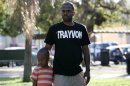 Jovan Blacknell and his son Justice attend a peaceful protest of the acquittal of George Zimmerman for the 2012 shooting death of Trayvon Martin, in Los Angeles