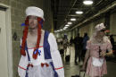 FILE - This Sept. 24, 2008 file photo shows Oakland Athletics rookie pitcher Brad Ziegler, left, heading to board the team bus after their 14-4 loss to the Texas Rangers in baseball game in Arlington, Texas. That hazing ritual of dressing up rookies as Wonder Woman, Hooters Girls and Dallas Cowboys cheerleaders is now banned. Major League Baseball created an Anti-Hazing and Anti-Bullying Policy that covers the practice. As part of the sport's new labor deal, set to be ratified by both sides Tuesday, Dec. 12, 2016 the players' union agreed not to contest it. (AP Photo/LM Otero)