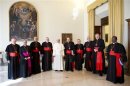 Pope Francis poses with cardinals during a meeting at the Vatican