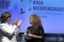 CNN journalist Christiane Amanpour, left, applauds after she handed over the 2015 Anja Niedringhaus Award to photographer Heidi Levine, right, in Berlin, Germany, Thursday, June 25, 2015. The Anja Niedringhaus Courage in Photojournalism Award was created to honor the life and work of Pulitzer Prize-winning AP photographer Anja Niedringhaus (1965-2014). (AP Photo/Michael Sohn)