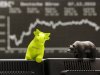 A toy bull and bear stand on a computer screen in front of the curve of the German stock index DAX that reached more than 7000 points on Tuesday, Dec. 7, 2010. (AP Photo/Michael Probst)