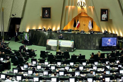 Iranian Foreign Minister Mohammad Javad Zarif (C) addresses the parliament in Tehran on November 27, 2013, as MPs review an accord struck with world powers over Iran's controversial nuclear programme