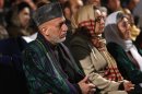 Afghan President Hamid Karzai sits during an event to mark International Women's Day in Kabul