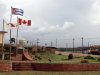 In this June 22, 2011 photo, a Canadian flag flies alongside the Cuban flag at the entrance of Pedro Sotto Alba nickel processing plant in Moa, Holguin province, Cuba.  A Cuban court has convicted a dozen people of corruption, including high-ranking government officials, an executive at a state-run nickel company and workers from a project operating under a Cuban-Canadian joint concern, official media announced Tuesday, Aug. 21, 2012. (AP Photo/Ismael Francisco, Cubadebate)
