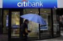 FILE - In this Tuesday, Jan. 14, 2014, file photo, a person walks past a Citibank location, in Philadelphia. As announced Thursday, March 20, 2014,a ll but one of the nation's 30 largest banks are in a stronger position to withstand a severe U.S. recession and a global downturn than at any time since the financial crisis, the Federal Reserve has determined .(AP Photo/Matt Rourke)