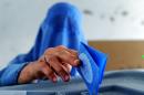 An Afghan resident casts her ballot at a polling station in Herat on June 14, 2014