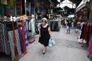 An elderly woman holds shopping bags as she leaves from a market area in the northern Greek port city of Thessaloniki, Wednesday, June 10, 2015. Greece has three weeks left to conclude a deal with its creditors before its bailout program expires at the end of the month. It is desperate for the disbursal of the final 7.2 billion euros in rescue loans, without which it cannot continue to repay its international debts. (AP Photo/Giannis Papanikos)