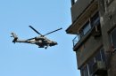 An Egyptian army helicopter flies over Cairo University on July 26, 2013
