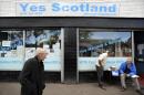 A pedestrian walks past the Yes Scotland campaign office in Maryhill, Glasgow on August 19, 2014