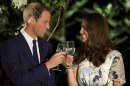 Britain's Prince William and his wife Catherine, the Duchess of Cambridge, make a toast in the honour of Queen Elisabeth's Diamond Jubilee at a British Gala reception at the Eden Hall in Singapore