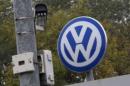 A Volkswagen logo stands next to a CCTV security camera in Wolfsburg
