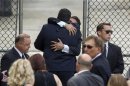 Mourners embrace outside the funeral services of James Gandolfini at the Cathedral Church of Saint John the Divine for funeral services in New York