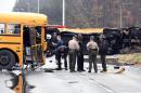 Authorities work the scene of an accident involving two school buses in Knoxville, Tenn., Tuesday, Dec. 2, 2014. Knoxville Police Department spokesman Darrell DeBusk said 
