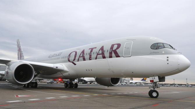 The new Airbus A 350 of Qatar Airways coming from Doha, Qatar, approaches the gate at the airport in Frankfurt, Germany, Thursday, Jan. 15, 2015. Qatar Airways is the first airline in the world to fly the Airbus A 350. (AP Photo/Michael Probst)