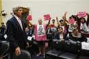 U.S. Secretary of State Kerry faces protesters against a military strike in Syria, as he arrives at a U.S. House Foreign Affairs Committee hearing in Washington
