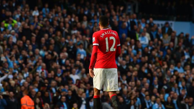 Manchester United&#39;s English defender Chris Smalling leaves the pitch after being sent off for earning two yellow cards, in Manchester, northwest England on November 2, 2014