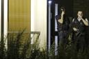 French police investigate an apartment in a residential building during a police raid in Boussy-Saint-Antoine