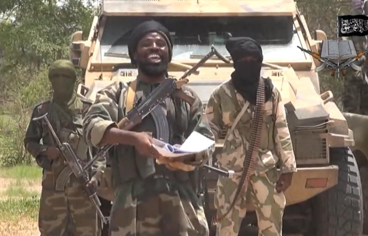 A screengrab taken from a video released by the Nigerian Islamist extremist group Boko Haram shows the leader of the Nigerian Islamist extremist group Boko Haram, Abubakar Shekau (centre) on July 13, 2014