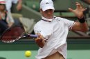 USA's John Isner returns the ball to France's Paul-Henri Mathieu during their second round match in the French Open tennis tournament at the Roland Garros stadium in Paris, Thursday, May 31, 2012. (AP Photo/Michel Euler)