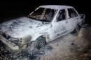 A burned down car remains at the crime scene where six people were executed by gunmen in Tetitlan de Las Limas, Chilapa, Guerrero state, Mexico on November 10, 2015