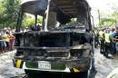 The charred remains of a bus, in which children died in, is seen in Fundacion