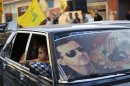 An image of Syria's President Assad is seen on a car's windscreen as Hezbollah supporters celebrate in Hermel