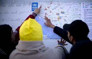 Migrants look at a map of the Western Balkans in a&nbsp;&hellip;