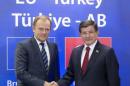 Turkish Prime Minister Ahmet Davutoglu is welcomed by European Council President Donald Tusk at the start of an EU-Turkey summit in Brussels