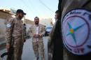 Members of the Assyrian Gozarto Protection Forces chat before heading to reinforce pro-government forces on the front line in the battle against the Islamic State group, in the northeastern Syrian province of Hasakeh on July 13, 2015