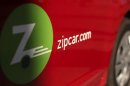 A logo is shown on the side of a Zipcar in San Francisco