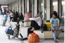 Passengers sit in a waiting room at a train station in Baghdad