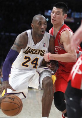Lakers shooting guard Kobe Bryant battles Rockets point guard Jeremy Lin for space during the second half of their NBA basketball game in Los Angeles