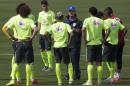 Brazil's coach Luiz Felipe Scolari, wearing a blue hat, gives instructions to his players during a practice session at the Granja Comary training center, in Teresopolis, Brazil, Monday, July 7, 2014. Brazil will face Germany on Tuesday in a World Cup semifinal match without Neymar. (AP Photo/Leo Correa)