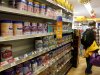 A man walks past shelves of baby formula at a shop in Hong Kong Friday, Feb. 1, 2013. Hong Kong announced measures Friday to curb the amount of baby formula that mainland Chinese visitors are buying as anger grows at shortages in the city's stores. Chief among the measures is a plan to change the law to restrict the amount of baby formula that individuals can take out of the city. Food and Health Secretary Ko Wing-man said legislation would be amended to prohibit taking more than 1.8 kilograms (4 pounds) of formula past Hong Kong's borders. The amount is equal to two cans of formula. (AP Photo/Vincent Yu)