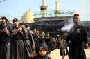 Shiite Muslim worshipers gather near the shrine of Imam Abbas as they prepare to commemorate Ashura in Karbala, 80 km south of Baghdad on November 13, 2013