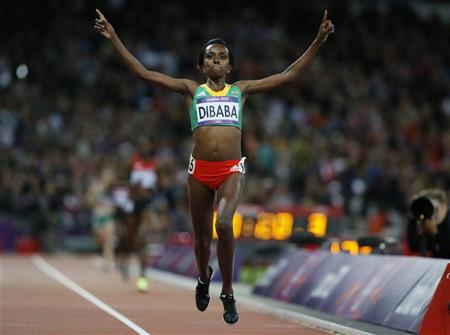 Ethiopia's Tirunesh Dibaba celebrates as she crosses the finish line in the women's 10000m final during the London 2012 Olympics Games at the Olympic Stadium