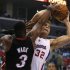 Miami Heat's Dwyane Wade defends as Los Angeles Clippers Blake Griffin attempts to put up a shot during their NBA basketball game in Los Angeles