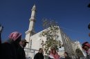 Palestinians gather outside a mosque in the village of Burka on December 15, 2011