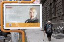 Woman walks by election poster of presidential candidate Hovannisin in Yerevan