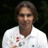 Spanish tennis player Rafa Nadal poses with playing cards depicting some of his 11 Grand Slam victories after an interview with Reuters in Madrid