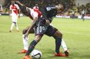 Lyon's Alexandre Lacazette, right, challenges for the ball with Monaco's Elderson Uwa Echiejile during their French League One soccer match, in Monaco stadium, Friday, Oct. 16, 2015. (AP Photo/Lionel Cironneau)