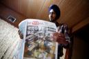 Gursewak Singh holds a Japanese newspaper as he prepares for an interview with Reuters, in Matsudo