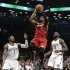 Miami Heat guard Dwyane Wade (3) goes up for a layup, between Brooklyn Nets guard Joe Johnson (7) and forward Reggie Evans (30) during the first half of on NBA basketball game Wednesday, Jan. 30, 2013, in New York. (AP Photo/Kathy Willens)