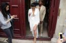 US reality TV star Kim Kardashian (L) and American singer Kanye West (R) leave their residence in Paris on May 23, 2014, ahead of their wedding