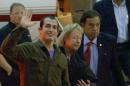 This image taken from a video shows Marine Sgt. Andrew Tahmooressi waving after arriving in Miami on Saturday, Nov. 1, 2014 in Weston, Fla. Tahmooressi is back home after a Mexican judge ordered his release from jail, where he spent eight months for crossing the border with loaded guns. Family spokesman Jon Franks told reporters that Tahmooressi arrived at a South Florida airport about 6 a.m. Saturday. Franks said Tahmooressi was resting with his family at their home suburban Weston, Fla. (AP Photo/Raul Torres) MANDATORY CREDIT