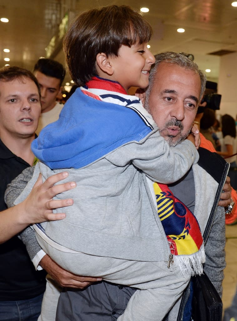 Osama Abdul Mohsen [R), the Syrian refugee who made world headlines when a Hungarian journalist tripped him over as he fled, and his son Zaid arrive...